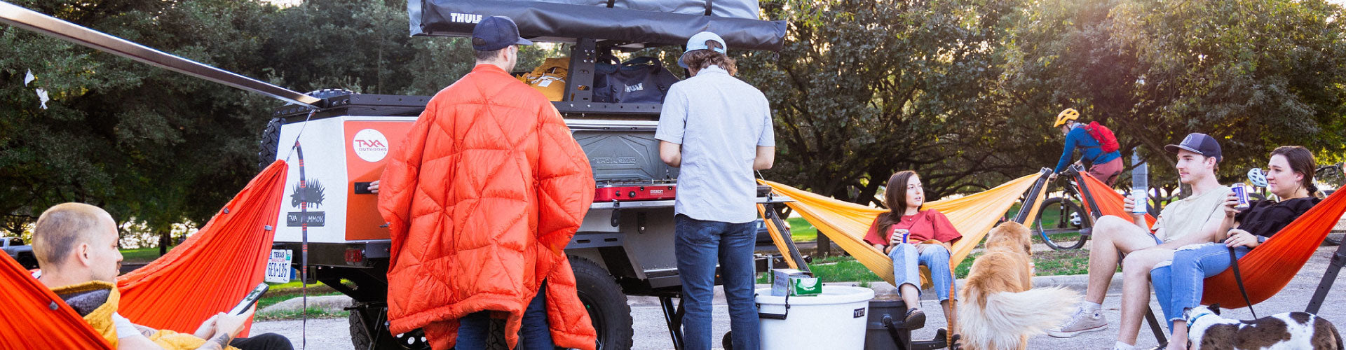 Tailgate with people sitting and lying in Kammok hammocks in Swiftlet Hammock Stands.