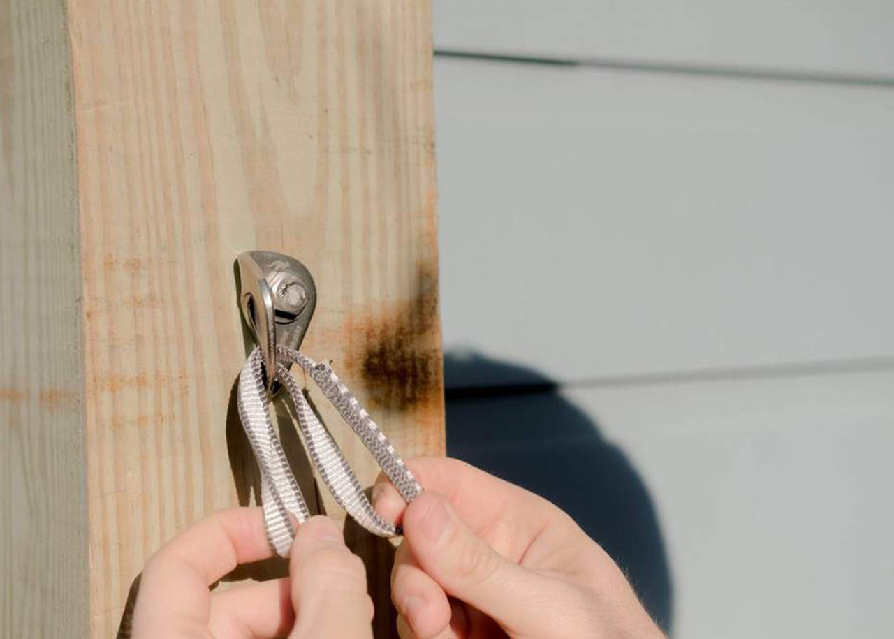 Close up of Kammok Accessory Bolt Pack installed on wood.